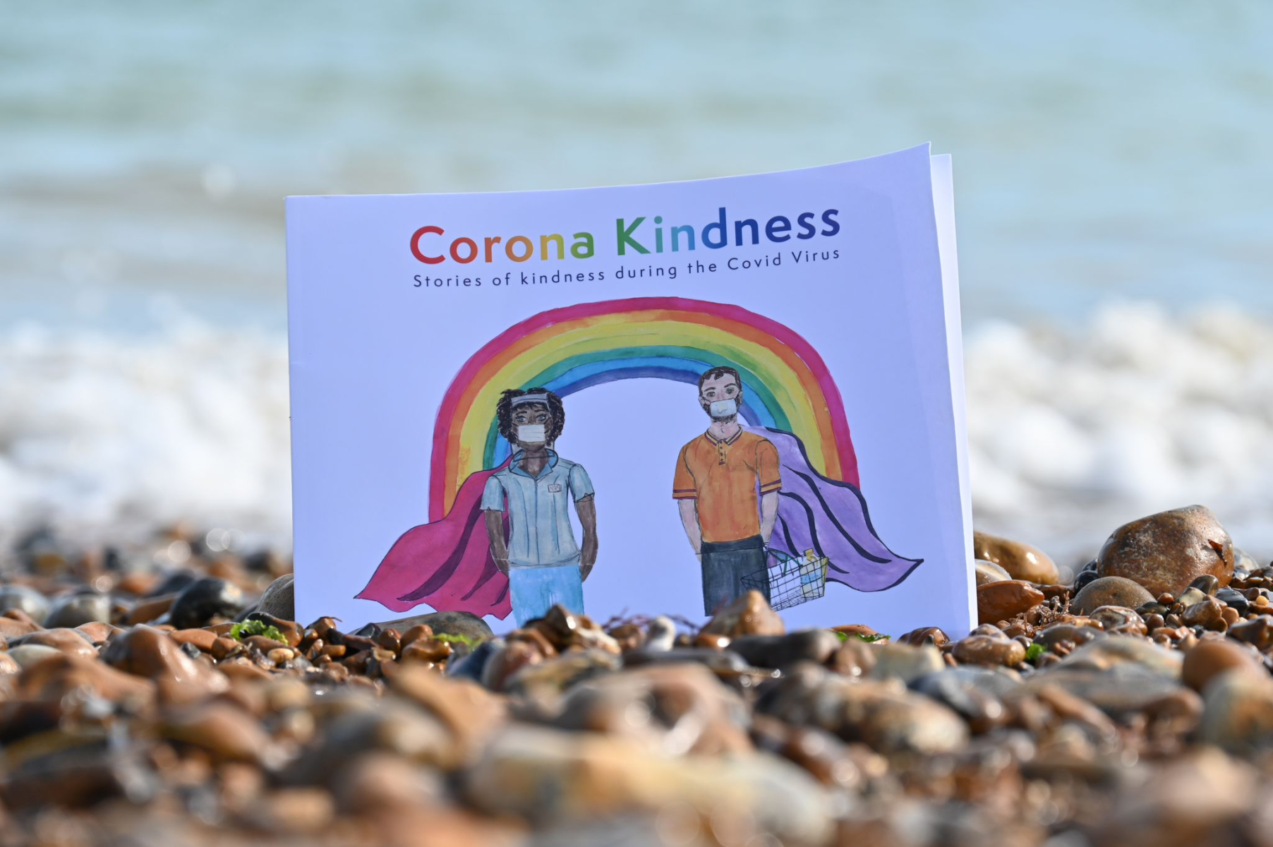 Corona Kindness book on a beach